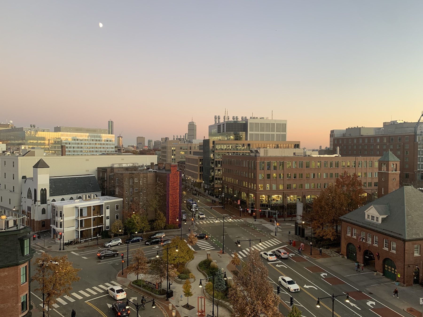 Sunset over Central Square. Soft glows of pink and orange settle over the city.