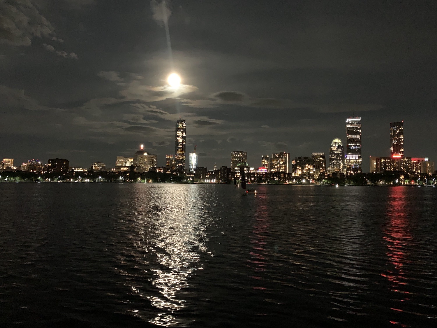 A blood moon over the night skyline of Boston.