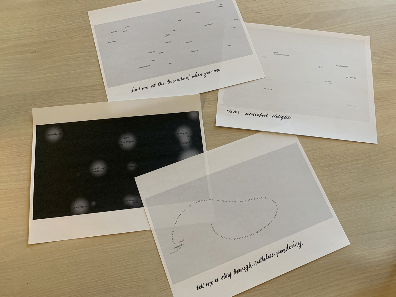 four sheets of paper on a table with poems printed on them